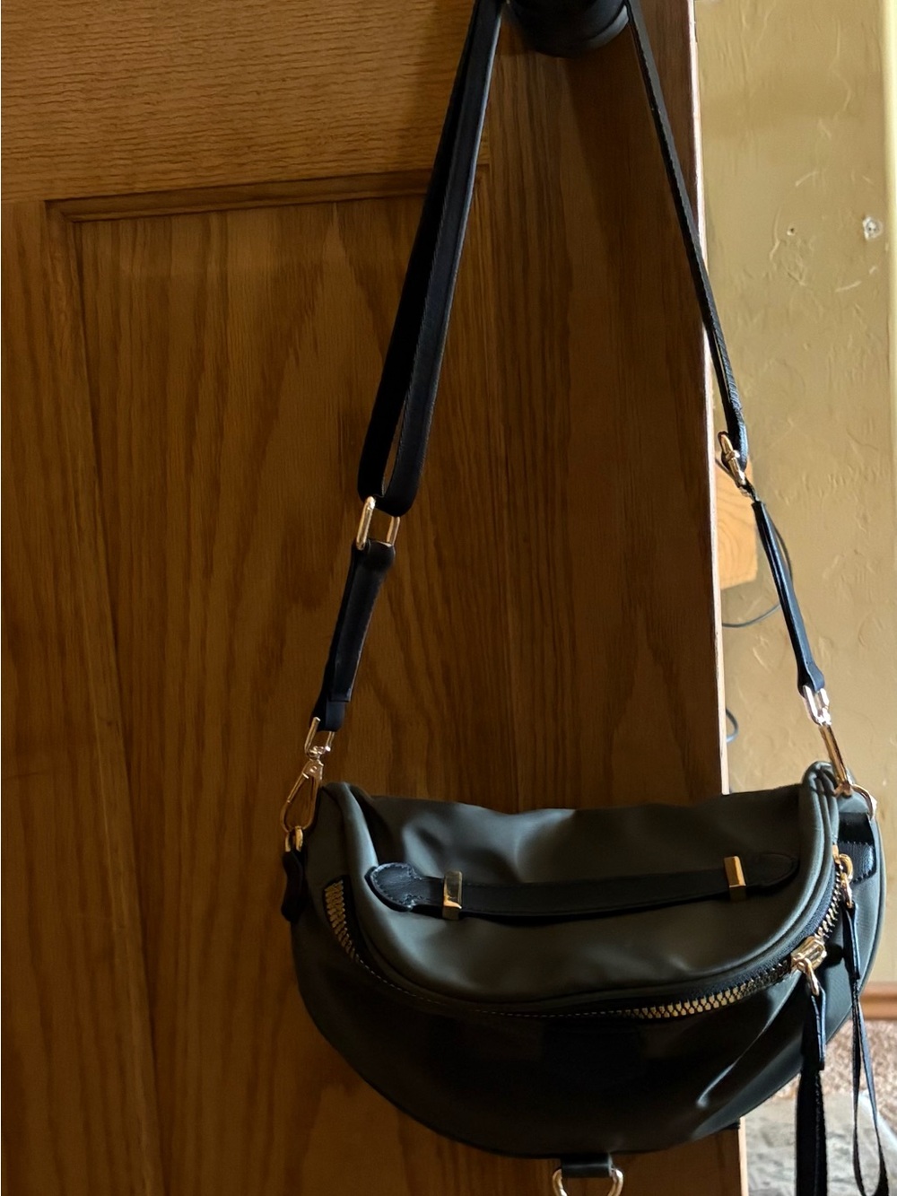 Elegant Black Crossbody Saddle Bag with Gold Accents